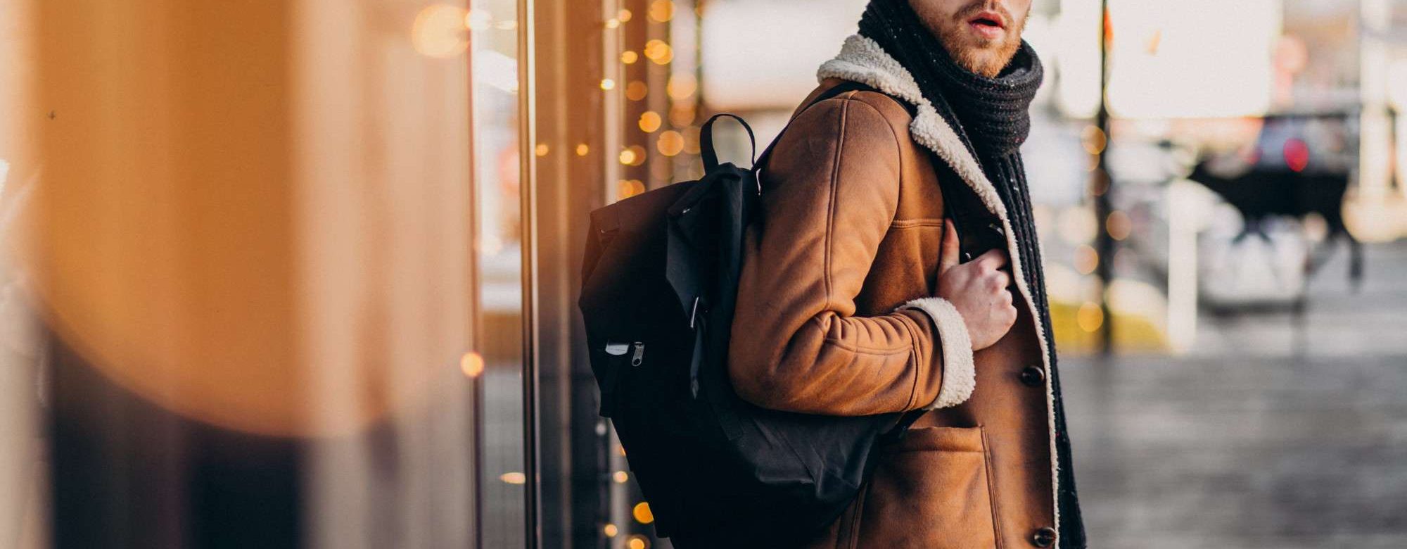 young-handsome-man-with-winter-clothes-backpack